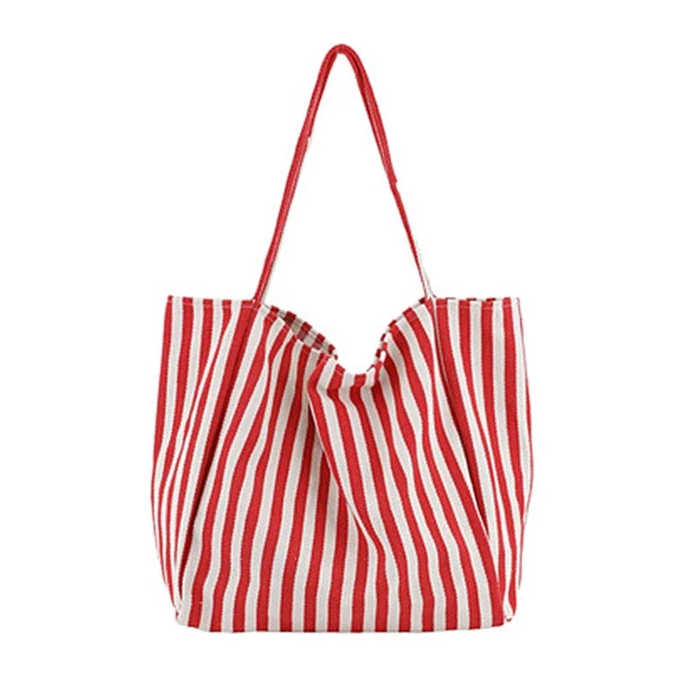 A red and white striped canvas tote bag with a drawstring top and inner pocket.