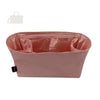 A pink luxury bag organizer insert featuring a silk lining and multiple compartments.