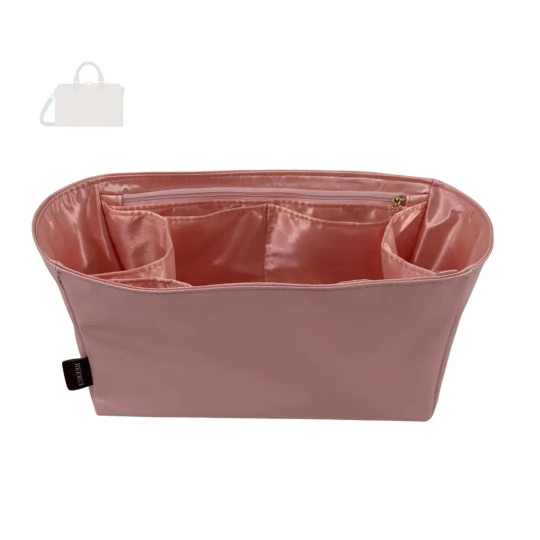 A pink luxury bag organizer insert featuring a silk lining and multiple compartments.