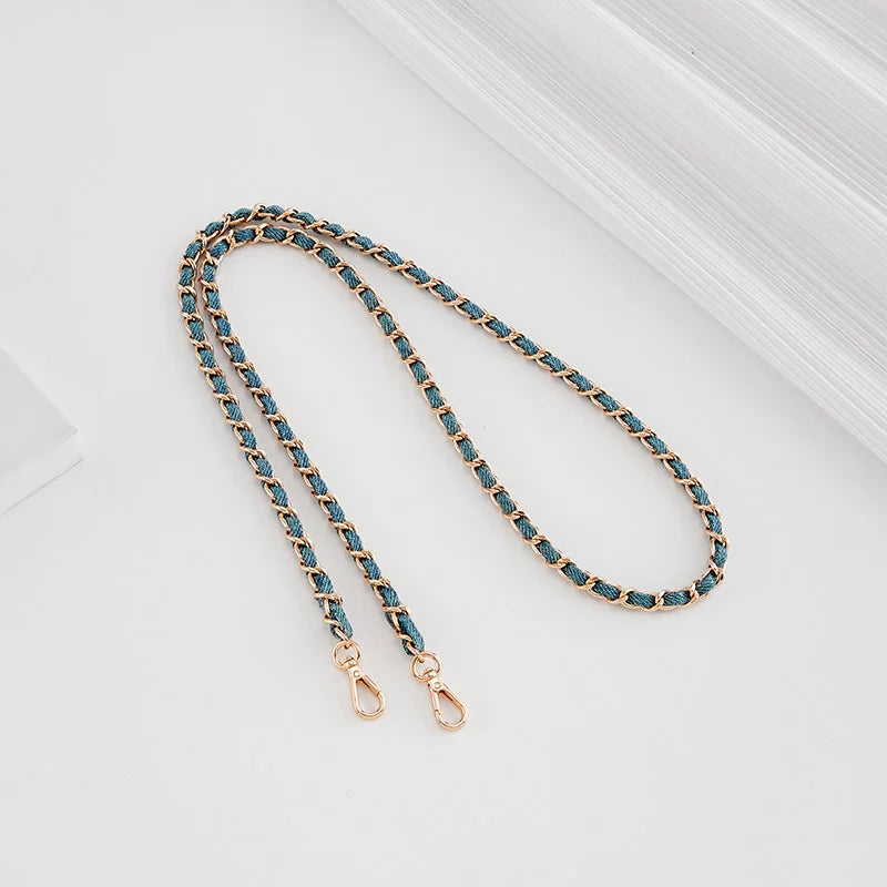 A delicate chain strap with blue beads and gold-toned buckles is displayed on a white background.