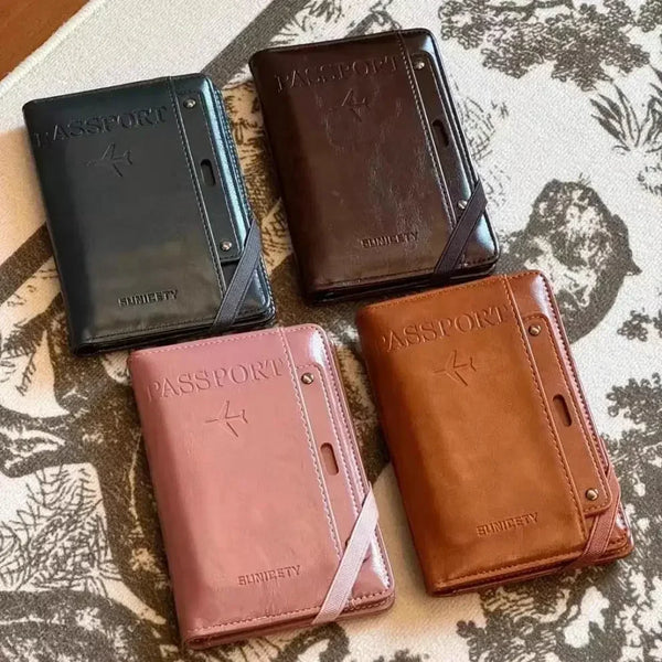 Three passport wallets in black, brown, and pink leather are displayed on a patterned surface.