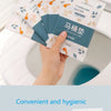 A hand is holding a pack of disposable toilet seat covers, featuring a floral pattern and blue accents.