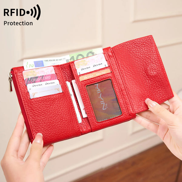 A red tri-fold RFID blocking wallet with a zipper closure is shown being held by a hand.