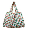 A reusable eco-friendly shopping bag patterned with strawberries and leaves.