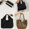 A black foldable mini keychain tote bag is shown in various views, including a hanging version and a brown leather version.