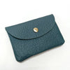 A dark teal genuine leather card holder and coin purse with a gold-toned clasp.
