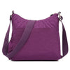 Lila wasserdichte Nylon-Crossbodytasche mit Trageriem auf weißem Hintergrund