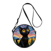 A black cartoon cat round crossbody bag with a colorful sunset landscape design.