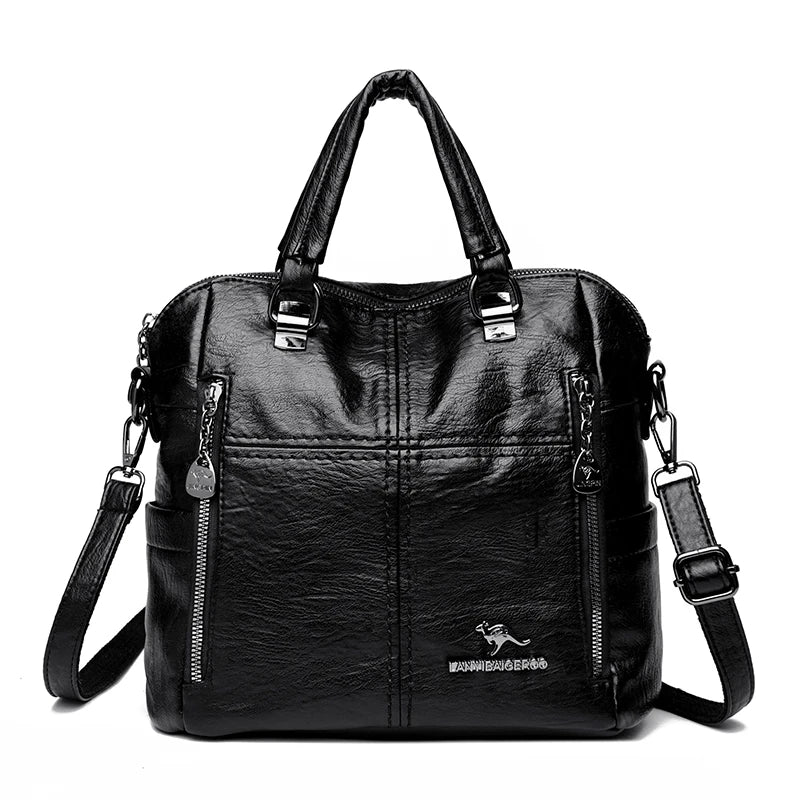 A black leather fashionable crossbody backpack bag with silver hardware.