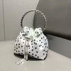 A white clutch bag embellished with silver studs and featuring a gold-toned chain handle.