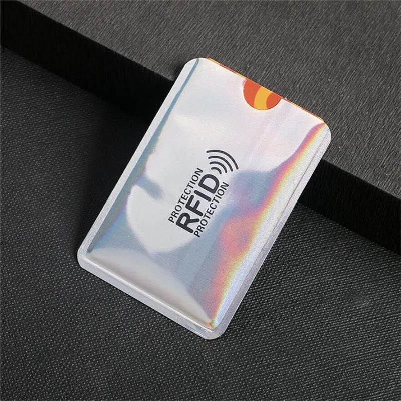 A close-up of a silver anti-RFID blocking card holder, showing the RF protection symbol.