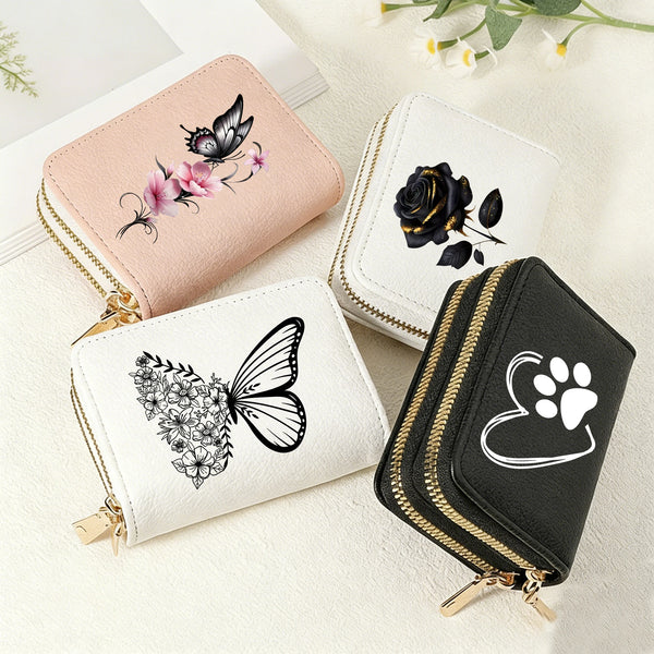 A collection of four heart-shaped zipper wallets featuring floral and butterfly prints in pink, black, white, and black.