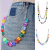 A necklace featuring colorful dice beads strung on a silver chain, displayed against a denim background.