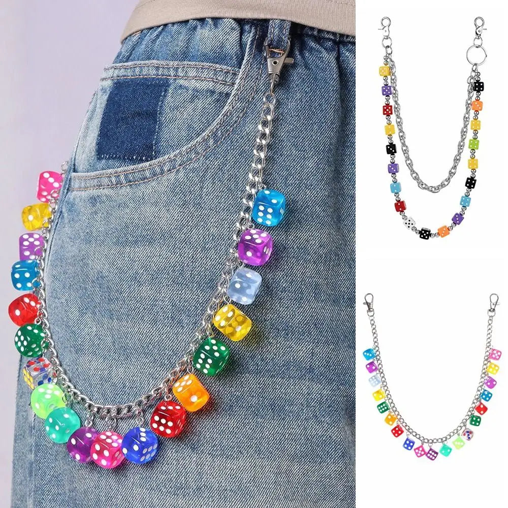 A necklace featuring colorful dice beads strung on a silver chain, displayed against a denim background.