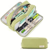 A light green pencil case is open, showing various colored pencils and stationery inside.