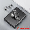 A black slim card holder wallet featuring a detailed skull design and silver-toned card clips.