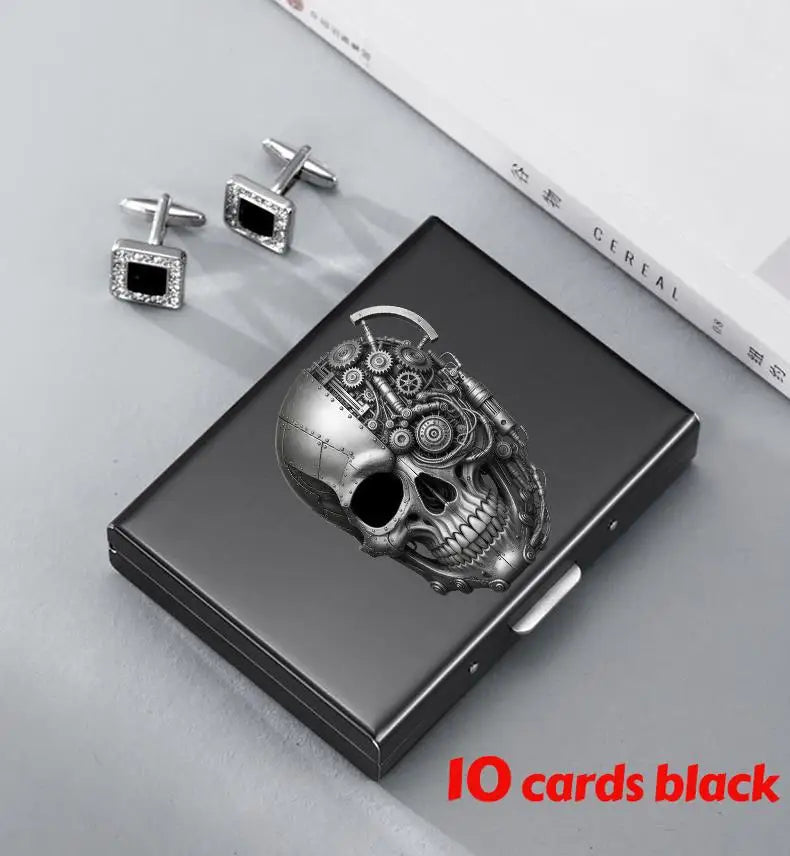 A black slim card holder wallet featuring a detailed skull design and silver-toned card clips.