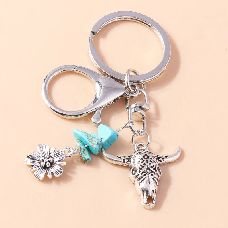 Silver gothic steampunk heart keychain featuring a sun eye pendant and a floral charm