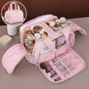 A pink portable side-zip cosmetic organizer bag is shown open, displaying various makeup and beauty products.