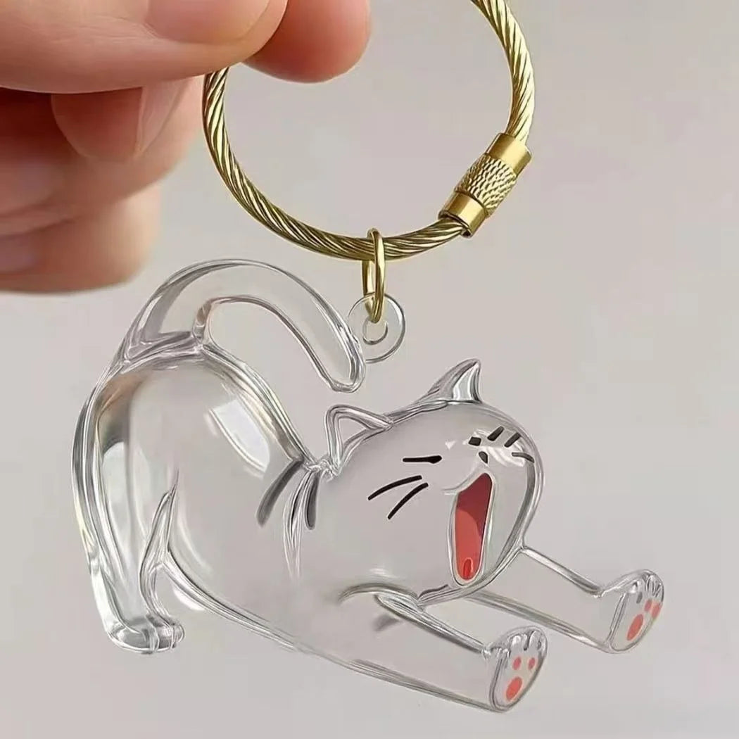 A clear acrylic pendant shaped like a cat is attached to a gold-colored chain.