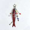 A red simulation fish keychain with silver charms and beads.