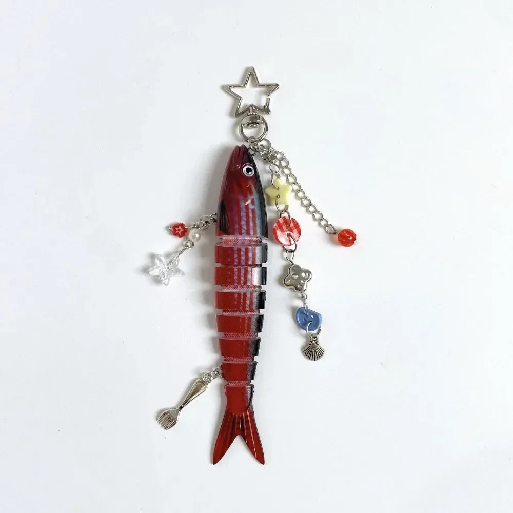 A red simulation fish keychain with silver charms and beads.