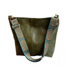 A dark olive green leather crossbody hobo bag with a patterned blue and brown strap.