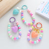 A set of colorful heart bead keychains with O-ring clips in shades of pink, blue, and yellow.