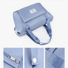 A light blue expandable travel organizer bag with a smooth pull head and quality hardware.