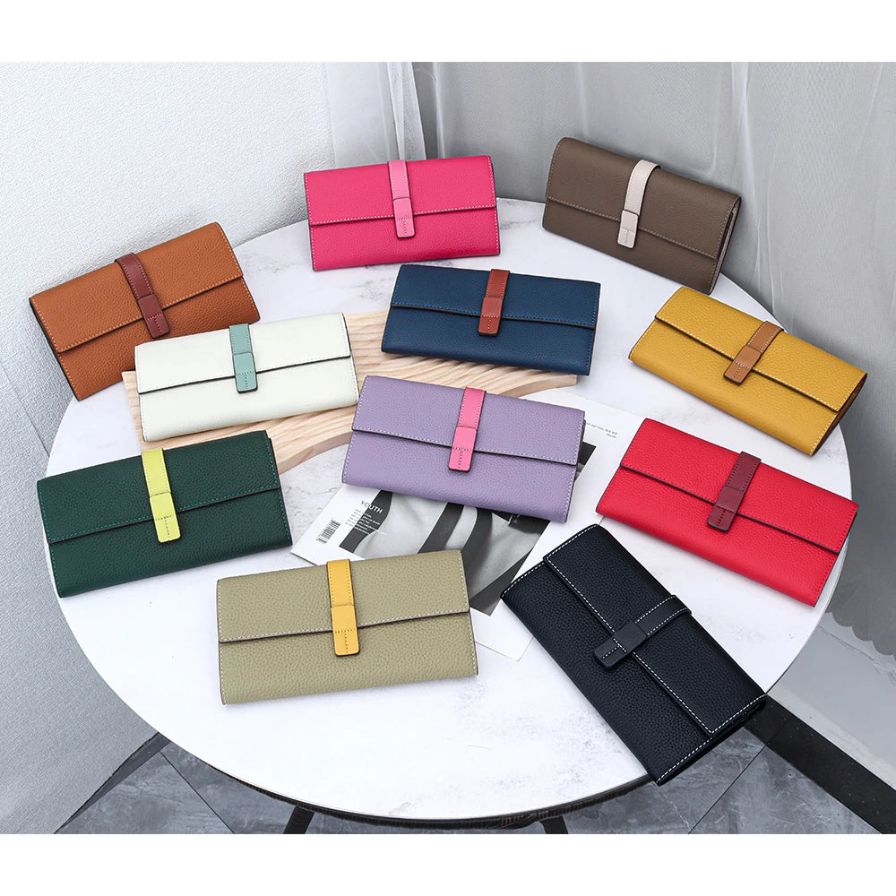 A collection of genuine cow leather bifold wallets in various shades of pink, brown, green, and yellow displayed on a white t