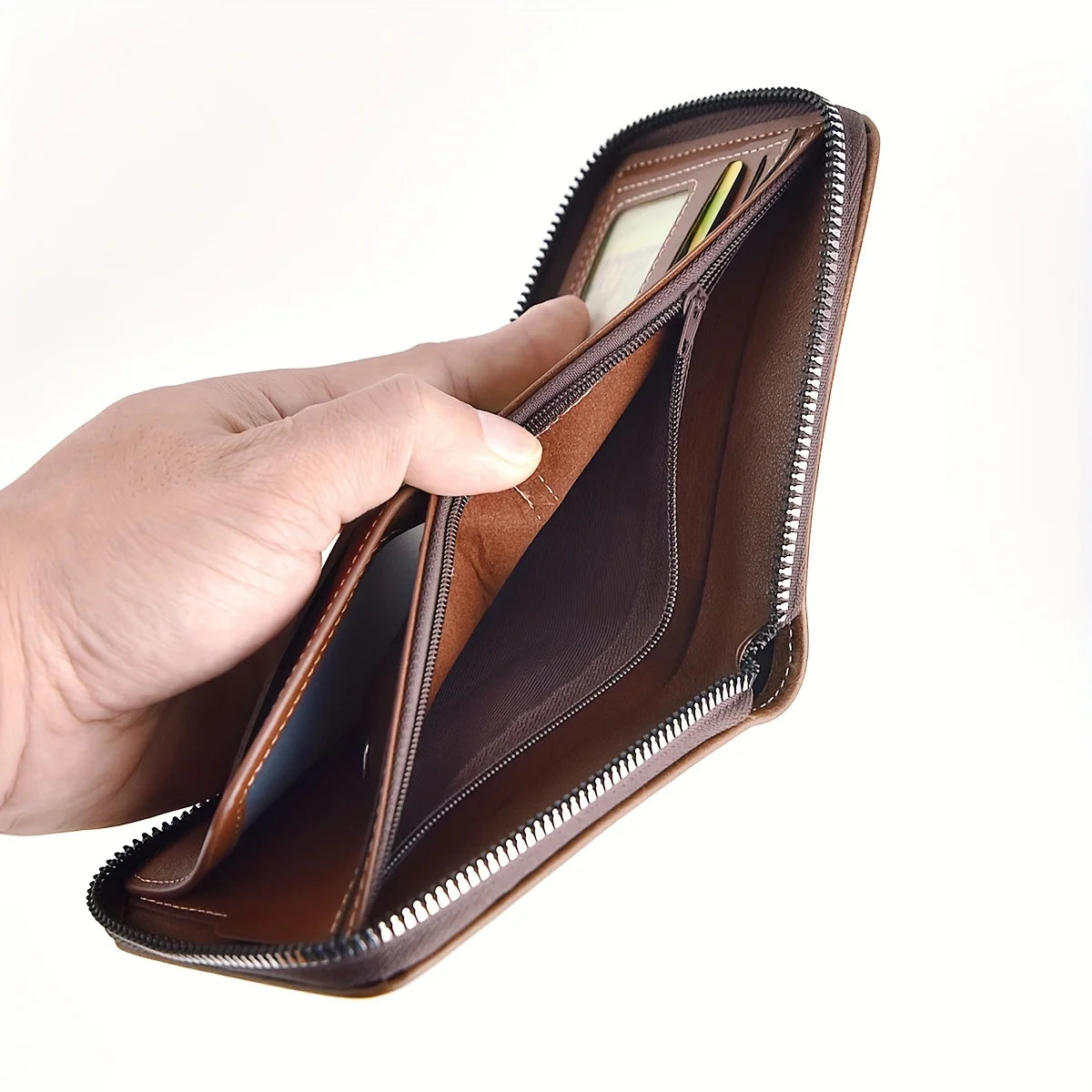 A hand opens a brown slim PU leather wallet with a zipper closure, showing the interior.