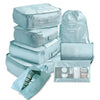 A set of light blue mesh packing cubes and a drawstring bag for travel organization.
