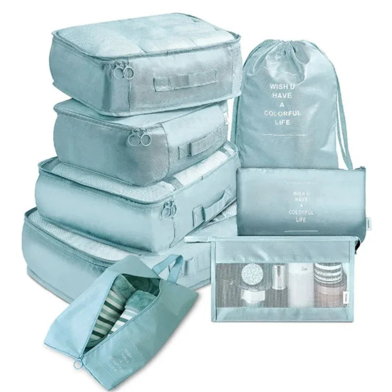 A set of light blue mesh packing cubes and a drawstring bag for travel organization.