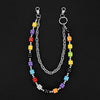 A silver chain necklace featuring colorful dice beads in various colors like yellow, purple, red, and black.
