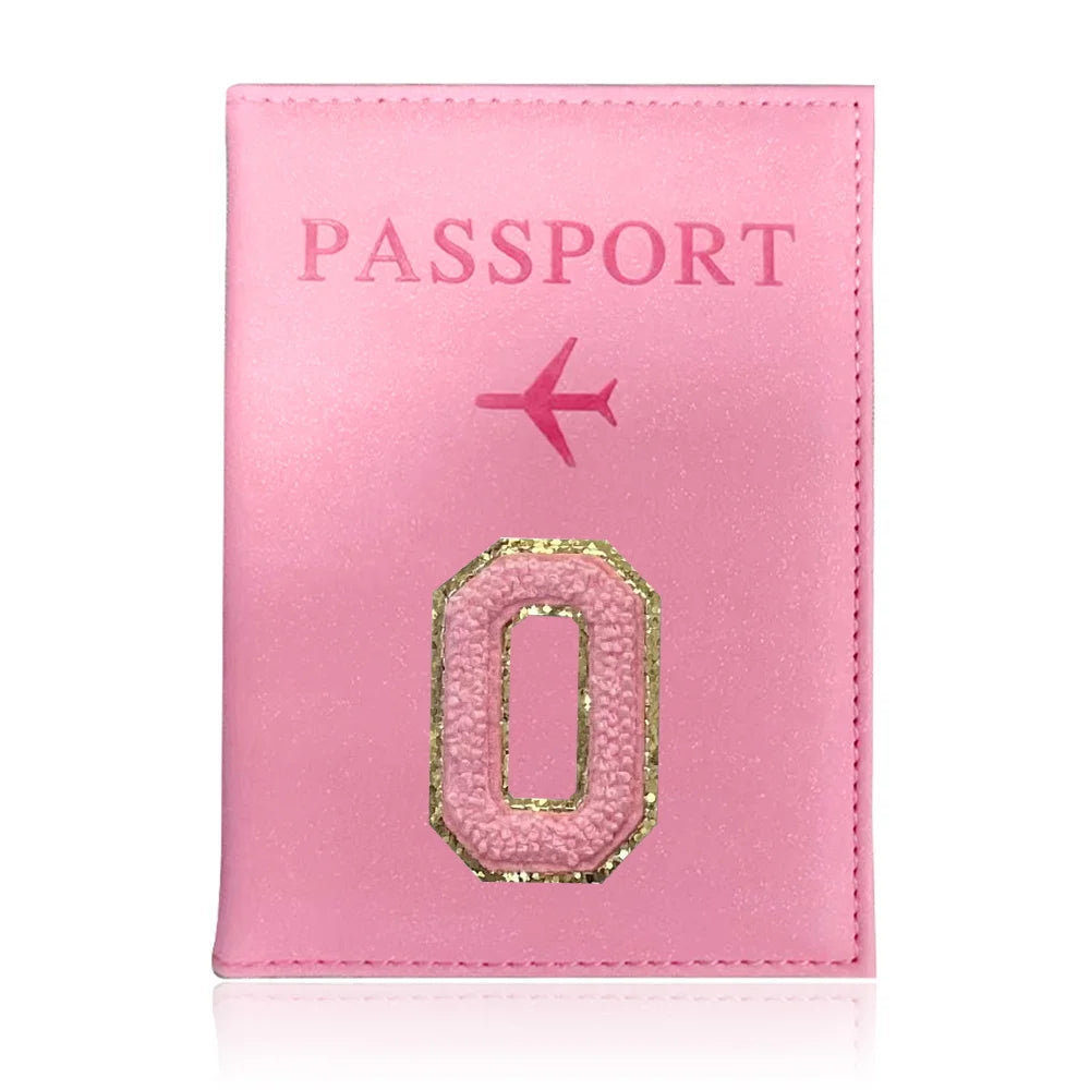 A pink leather passport holder with the word PASSPORT and the number 0 embossed on it.