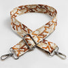 A beige and brown jacquard patterned strap for an adjustable wide crossbody bag.