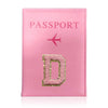 A pink leather passport holder with a gold embossed letter D and a pink airplane symbol.