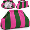A pink and green striped knit clutch bag with a compartment filled with small white items.