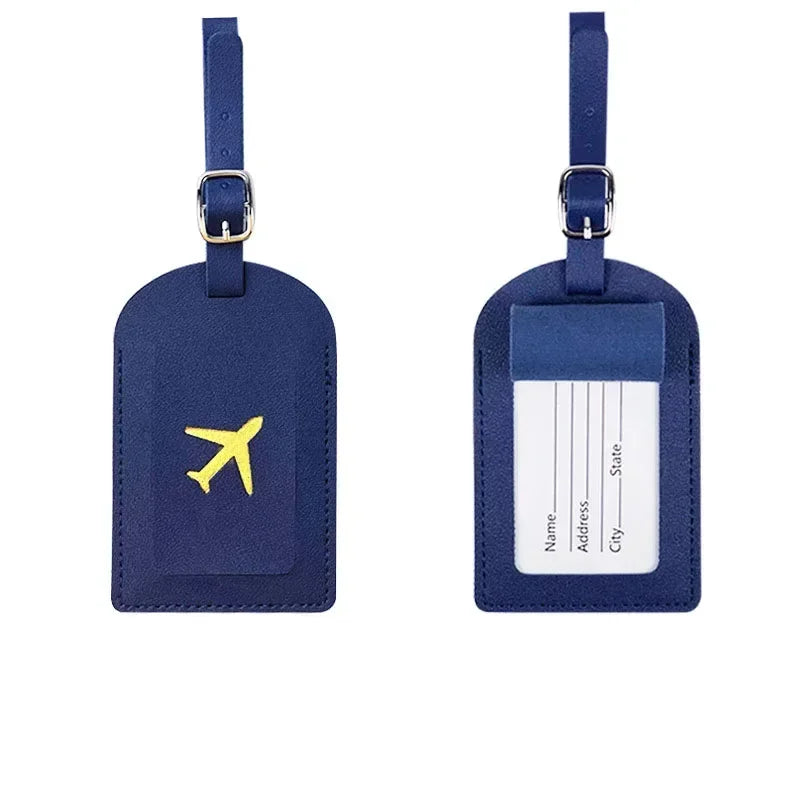 Two dark blue PU leather luggage tags with a yellow airplane design and a blank address section.