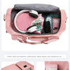 Pink large capacity travel duffle bag showing various compartments for clothing and gear