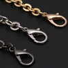 Close-up of gold and silver adjustable metal chain strap accessories for a crossbody bag.
