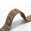A close-up of a brown and beige patterned textile replacement bag strap.