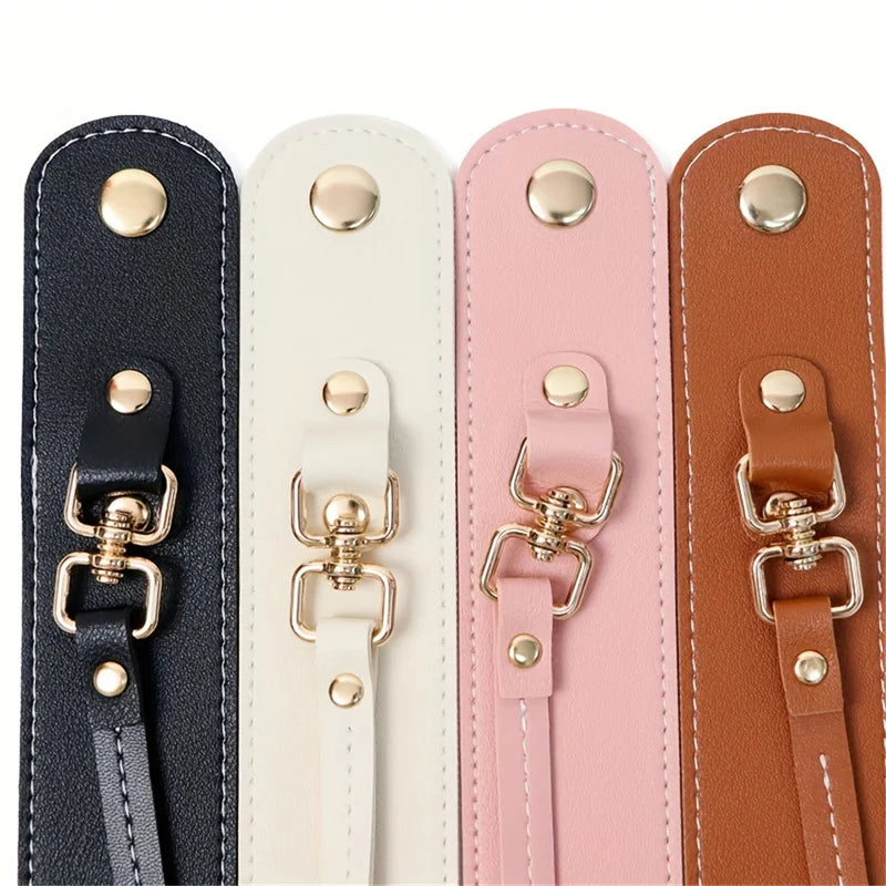 A set of four vintage leather glove holder straps in black, cream, pink, and brown.