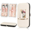 A beige cosmetic case holding a stainless steel nail clipper set with various tools and a personalized name design.