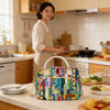 A colorful thermal storage bag with a light canvas strap sits on a kitchen counter.
