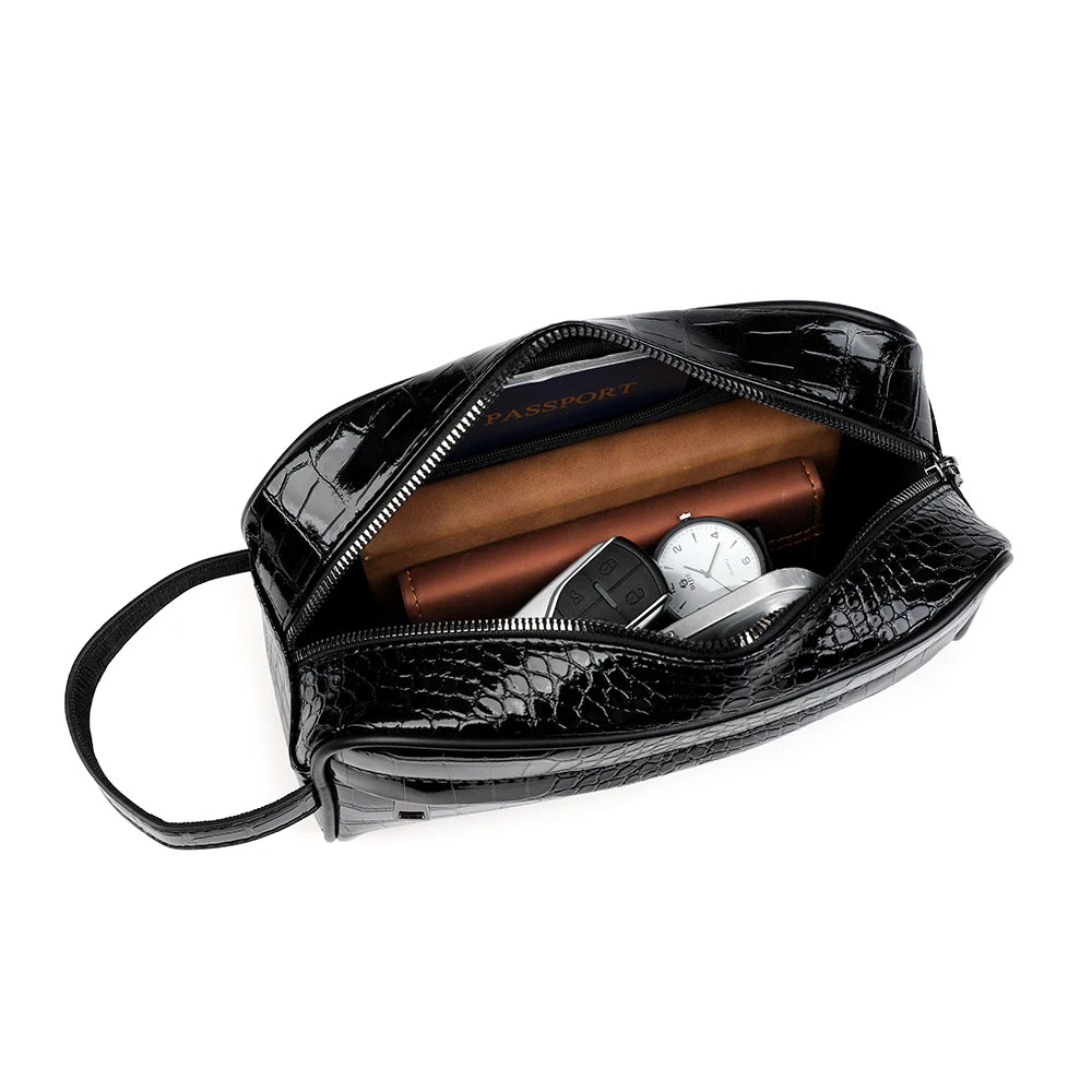 Black crocodile print clutch bag with a zipper and a leather watch inside