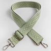 A beige woven strap with an arrow jacquard pattern, folded in an X shape.