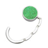 A round, sparkly green metal desk hook with a curved metal wire hanger.