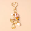 Gold-toned starfish and pearl accents keychain with a heart charm