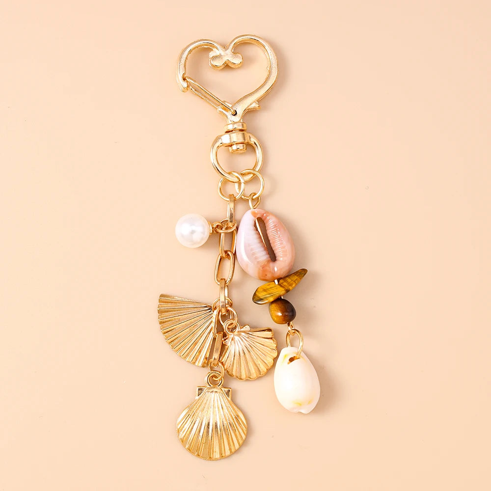 Gold-toned starfish and pearl accents keychain with a heart charm
